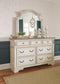 Realyn  Upholstered Panel Bed With Mirrored Dresser And Chest